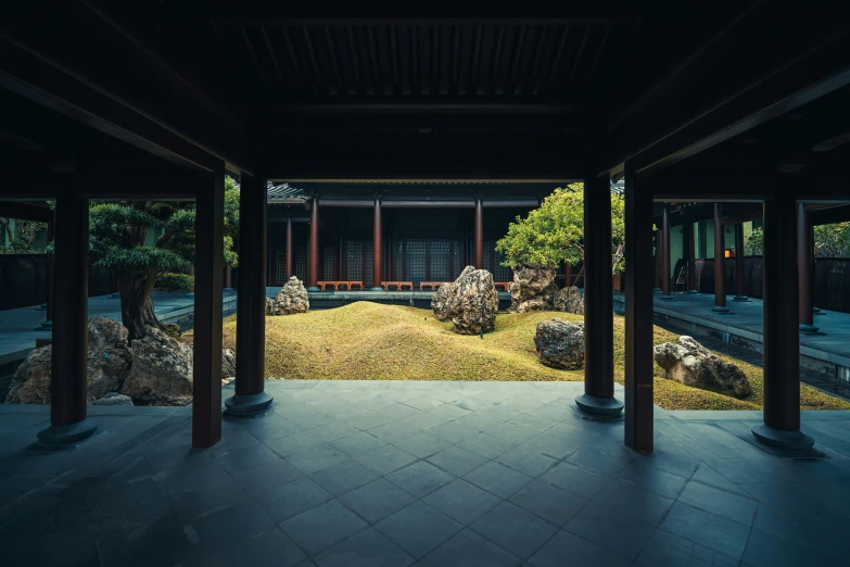 an empty room with a stone courtyard in the foreground