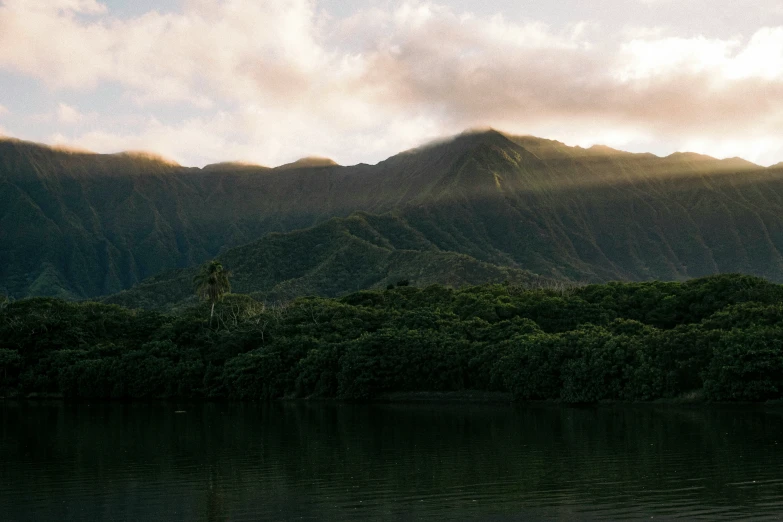 the mountain range is visible behind a river