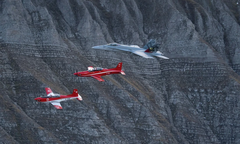 a trio of fighter jets flying through the sky