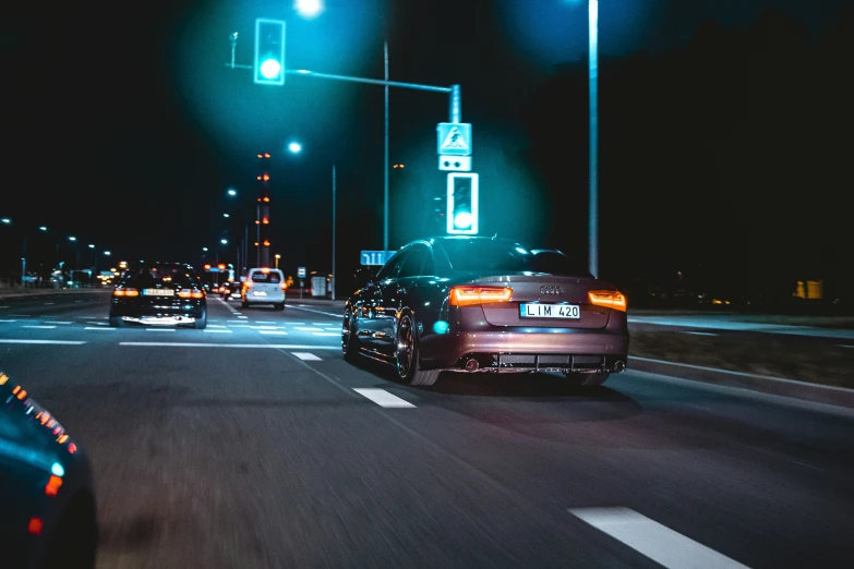 cars are going through the street at night