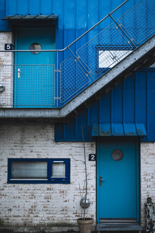 a blue door sitting next to a brick building