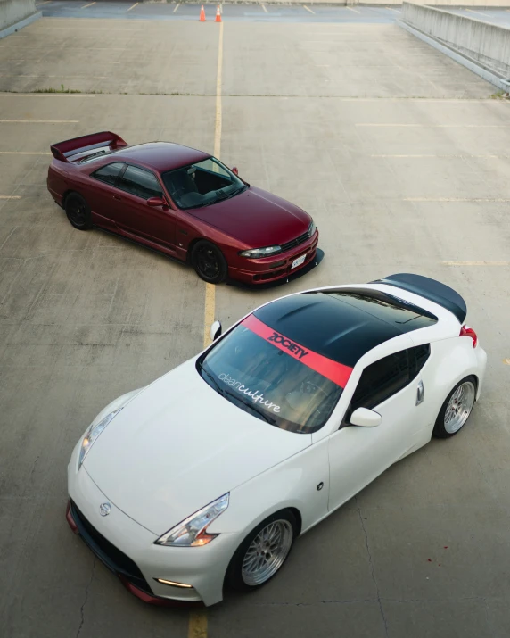 two sports cars parked in a parking space