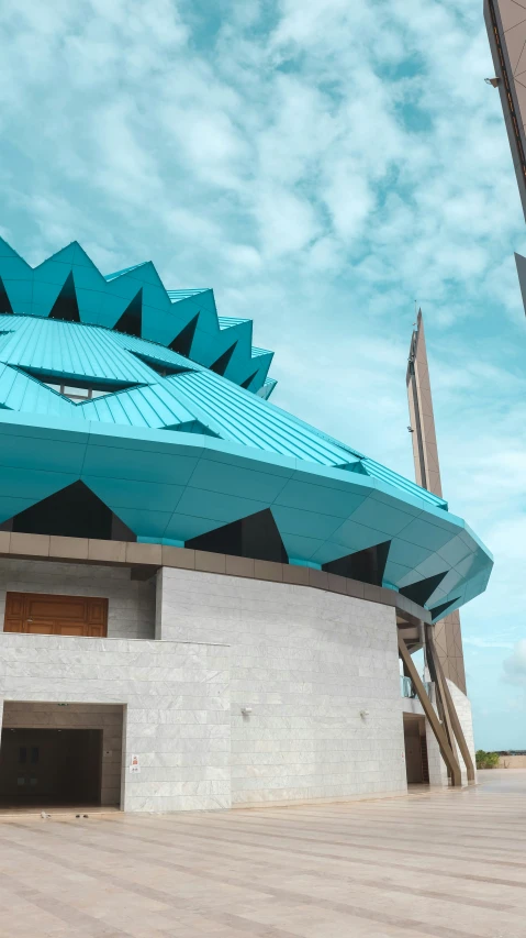 a building with a blue structure under a bright sky