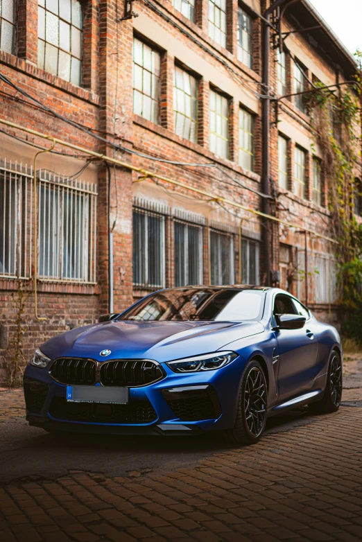 a blue car parked next to a building