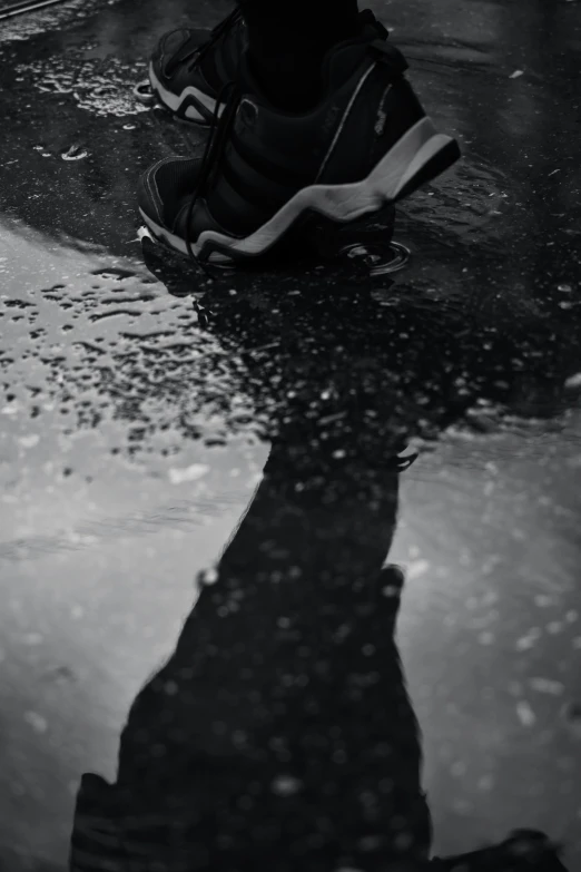 a person in sneakers is reflected in the dle