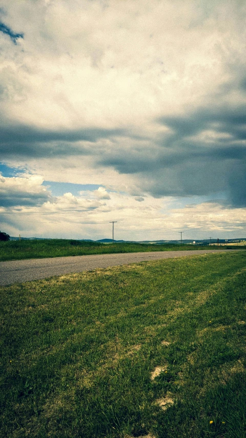 the wind direction sign is near a paved road