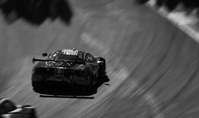 black and white pograph of a car driving on a hill