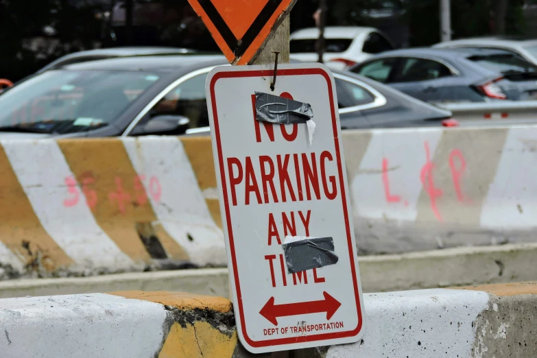 a sign that says no parking any time