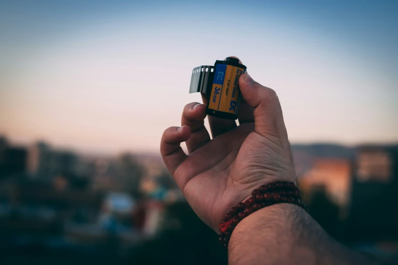 someone holding a small remote in their hand