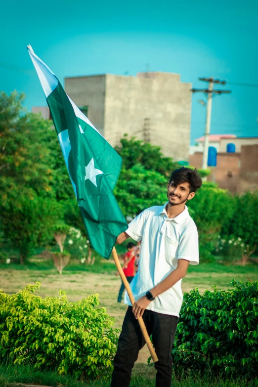 a person holding a flag with trees behind it