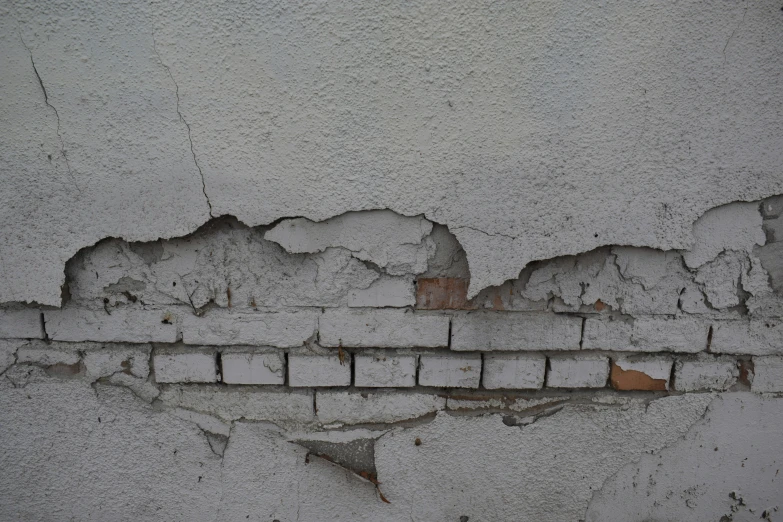 white paint on a surface showing peeling paint and ed surface