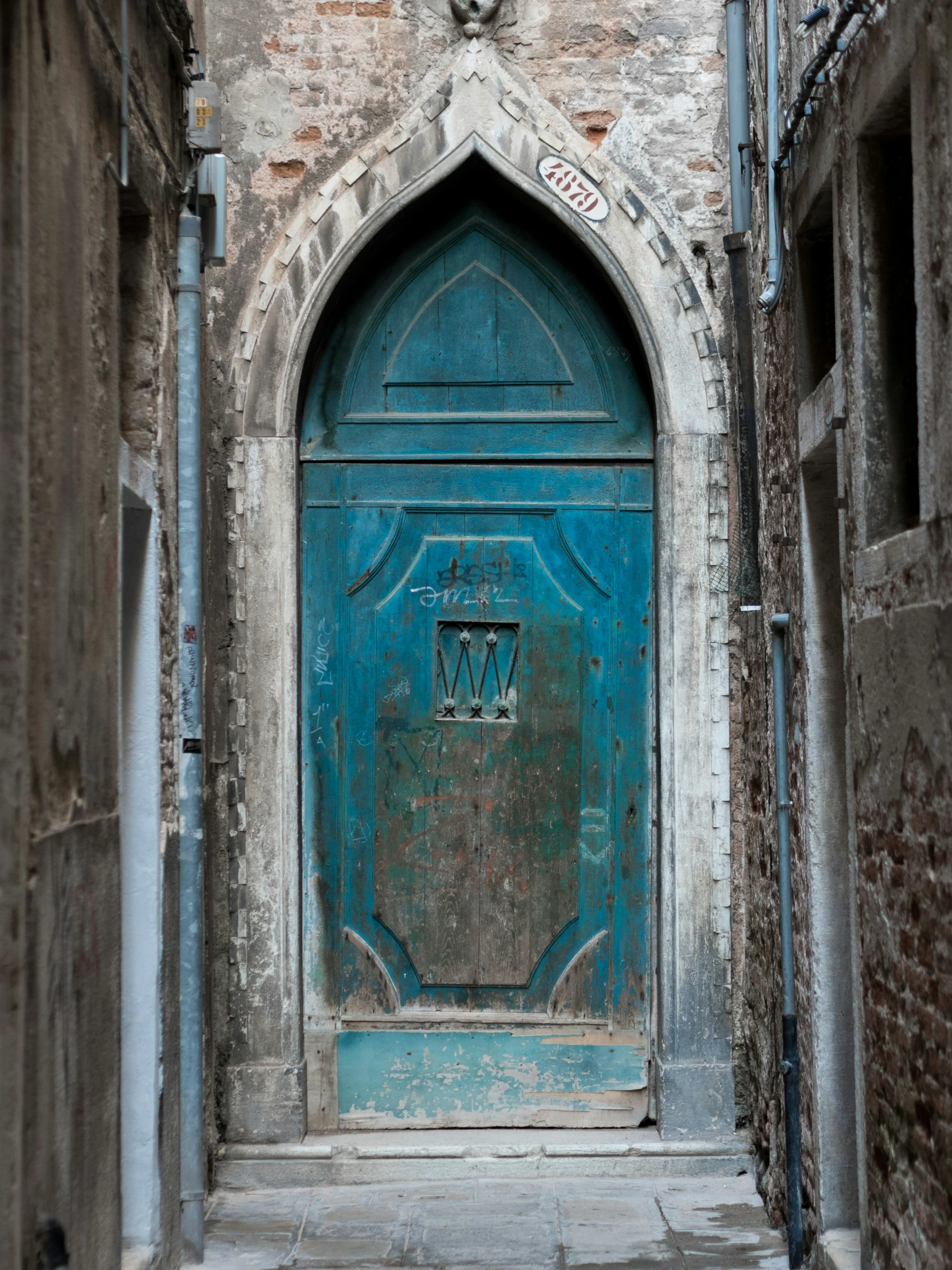 a blue door in an old brick building