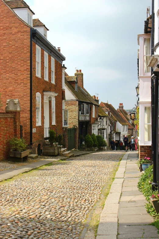 a cobblestone street with brick buildings