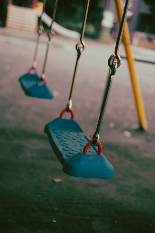 swings hang from the back end of an old playground