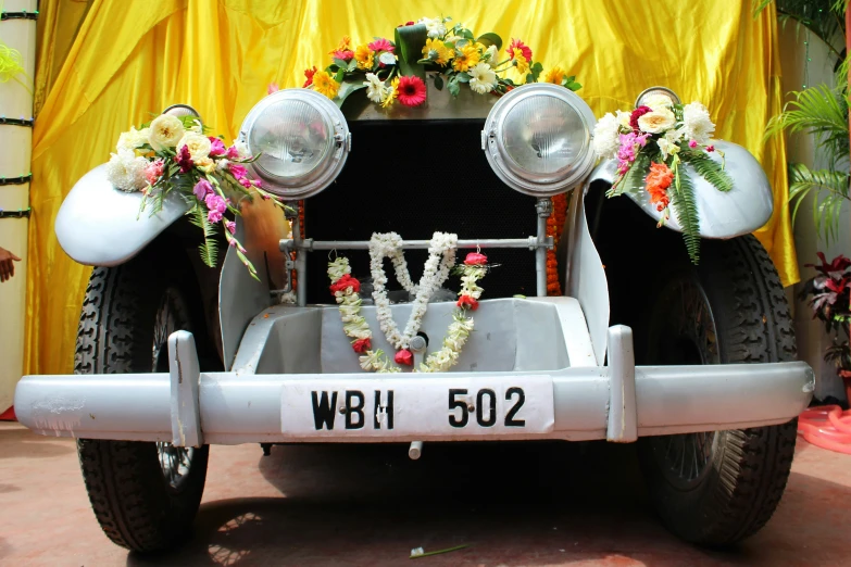 an old model t jeep decorated with flowers