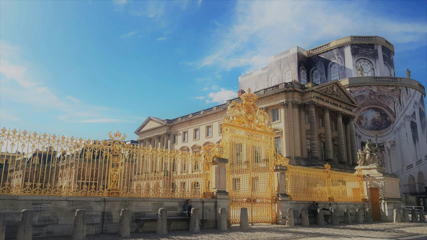 large golden decorative archway in front of tall building