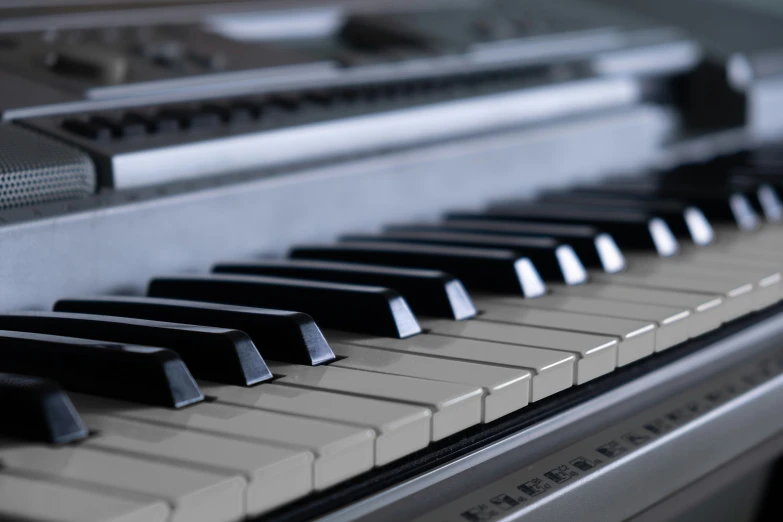 closeup of a piano keyboard with the keys down