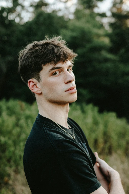 a man looking at the camera in a field