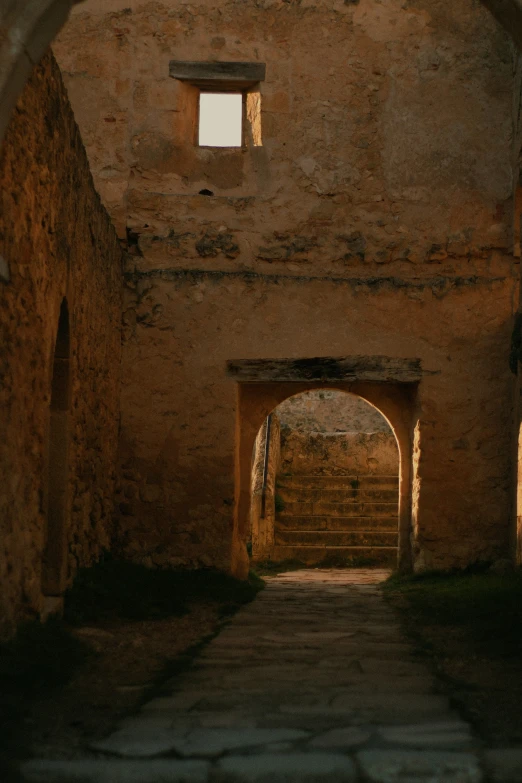 the view of an archway through the brick wall