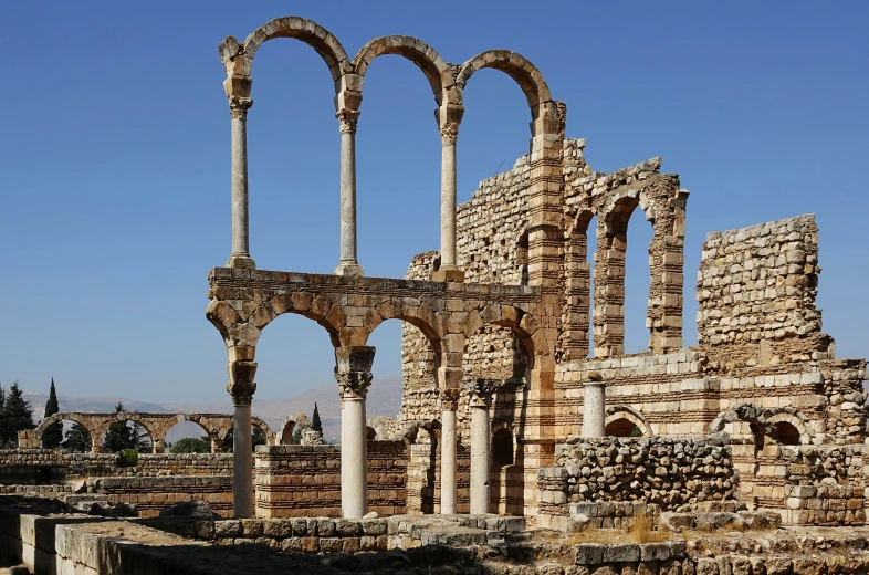 a view of the ruins of an ancient building, showing the arches and columns