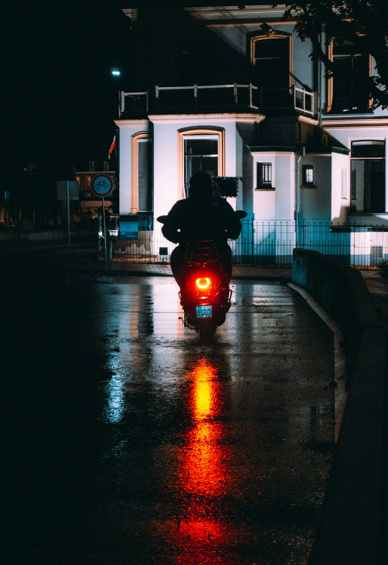 a motorcycle parked on a wet road at night