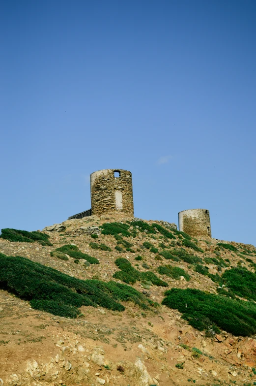 old brick ruins standing at the top of a hill