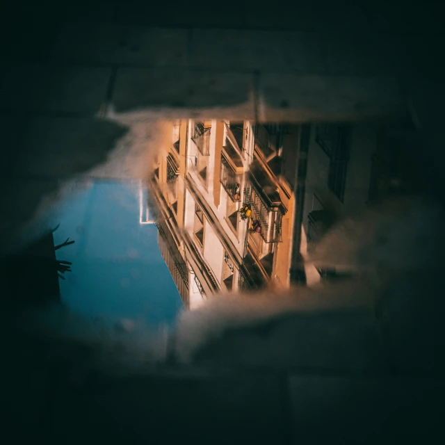 view from inside of window showing building below