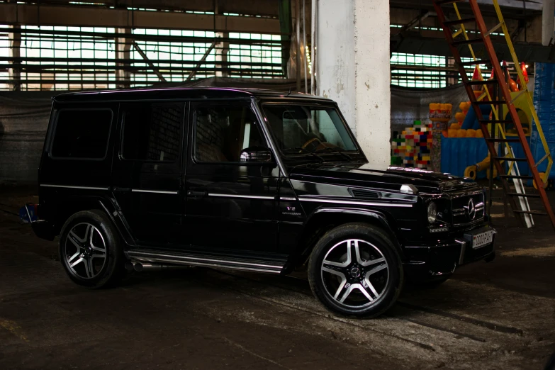 a black and grey suv parked in the parking garage