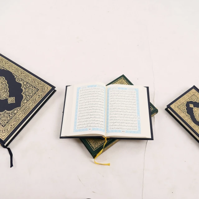 three book covers with an open book sitting on a table