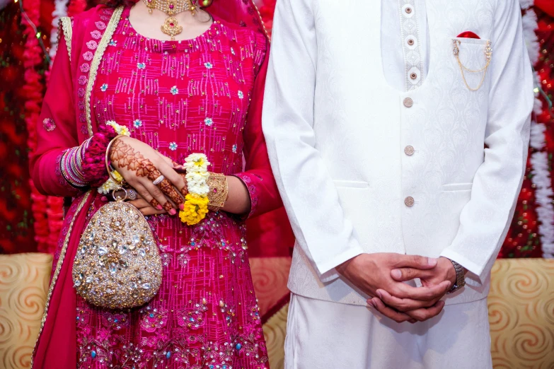 a bride and groom standing next to each other in front of flowers