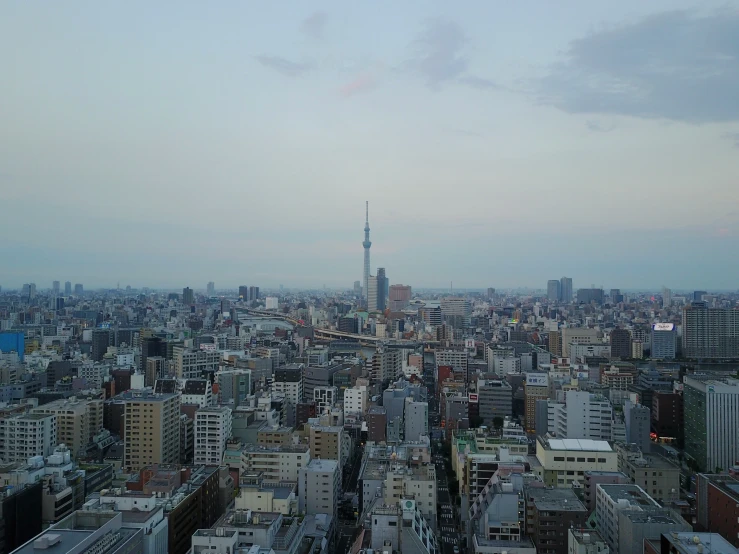 a cityscape with tall buildings and clouds at dusk