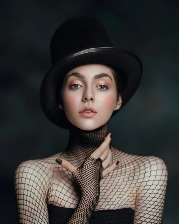 a young woman in fishnet bodysuit with black hat and necktie