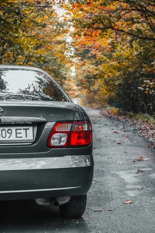 a car parked in a parking lot with fall colors