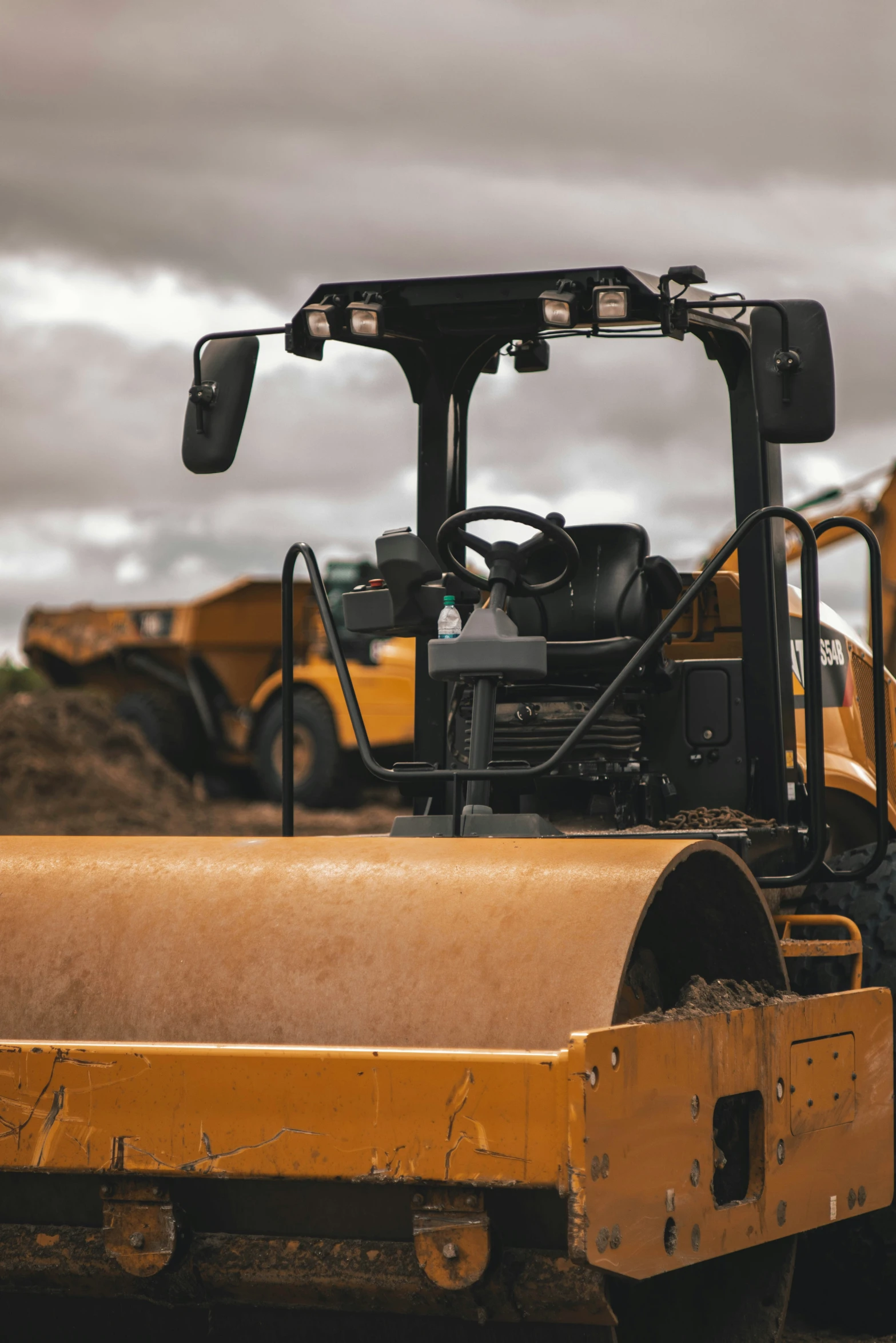 there are three yellow bulldozers parked next to each other