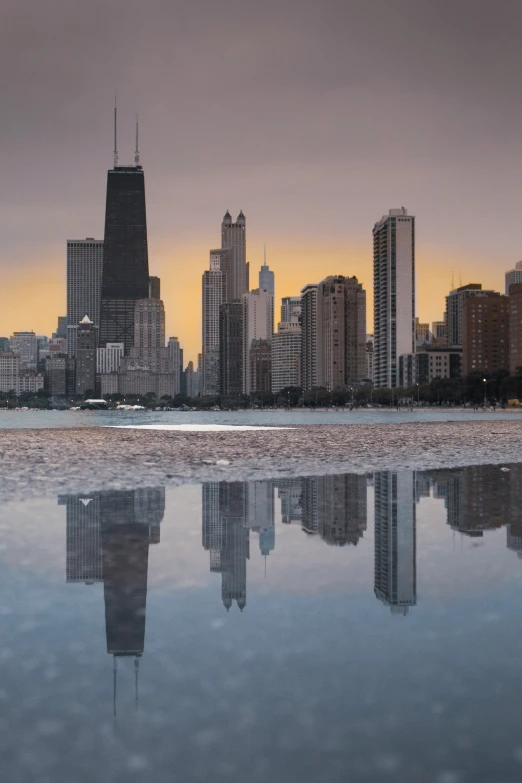 a city view is shown at dusk on the water