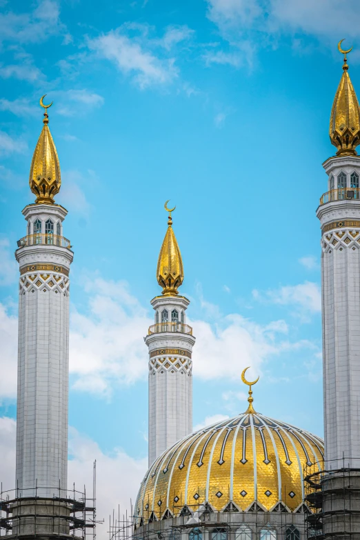 several gold and white domes are in the sky