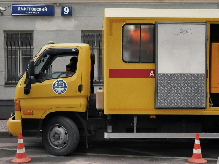 a yellow truck that has its door open