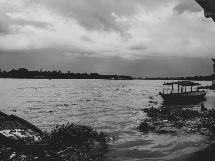 a boat on a body of water under a cloudy sky