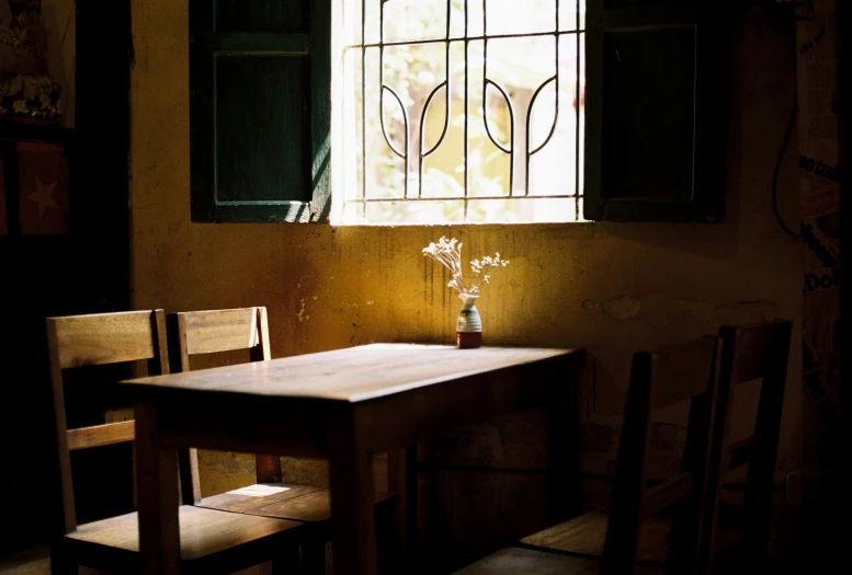 a table with two chairs sits near a window