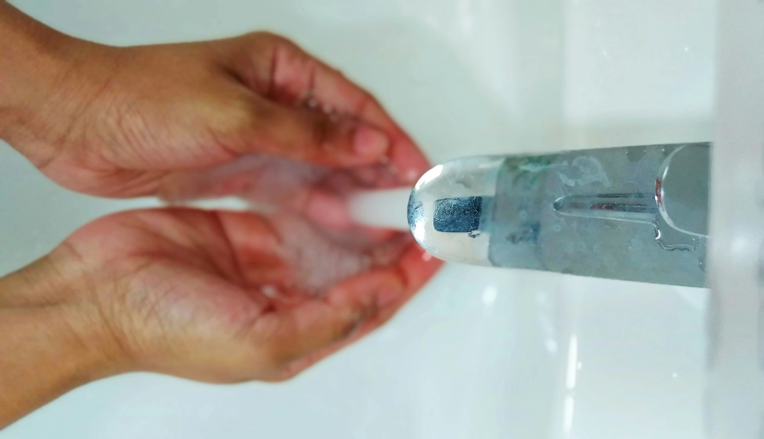 the woman's hands are holding an empty toothpaste