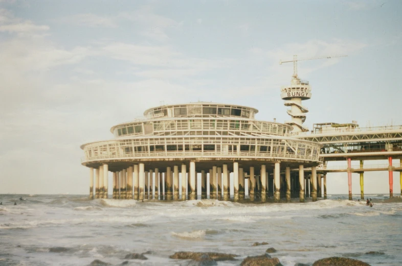 a building that is by some water with a tall structure