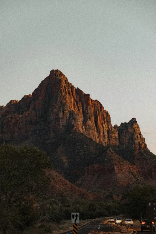 an image of a hill with mountains in the background