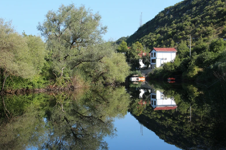 some water buildings and trees and blue sky