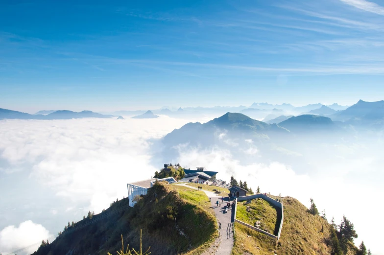 a building is perched atop a hill and high in the clouds