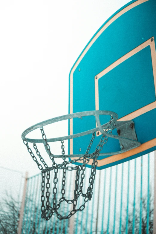 a basketball going up to the basket of a ball hoop