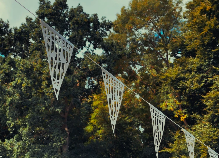 some white lacy flags are hanging in the trees