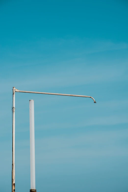 a street sign in front of a blue sky