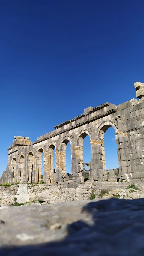 the ruins of an old temple are against a blue sky