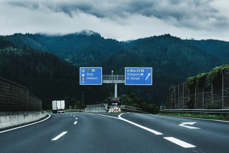 there are several signs on the highway pointing different directions