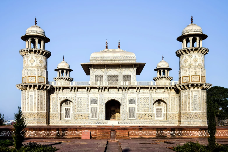 a large white building with three towers in the center of it